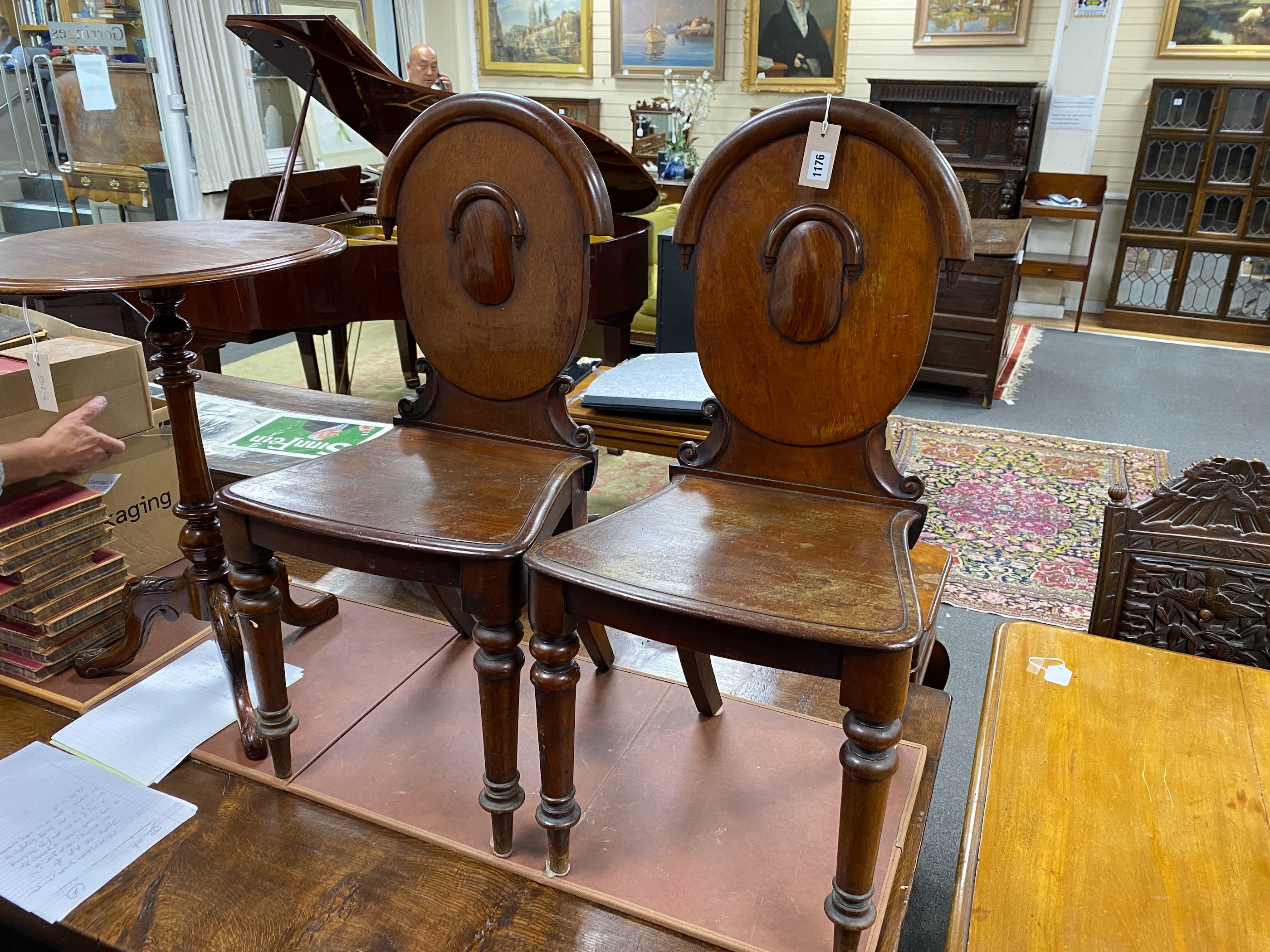 A pair of Victorian mahogany hall chairs